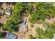 Aerial view of a home nestled among trees, highlighting a spacious yard and serene natural surroundings at 450 Cassady St, Umatilla, FL 32784