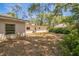 The backyard features lush trees and foliage and a well-maintained lawn, enhancing privacy at 450 Cassady St, Umatilla, FL 32784