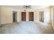 Large bedroom with neutral carpet, ceiling fan, and multiple closets for ample storage at 450 Cassady St, Umatilla, FL 32784