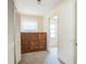 Hallway with built-in wooden cabinet, carpet floors and access to bedroom or closet at 450 Cassady St, Umatilla, FL 32784