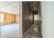 Hallway with access to the living room and backyard, featuring wood paneling and linoleum flooring at 450 Cassady St, Umatilla, FL 32784