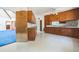 Eat-in kitchen with extensive cabinetry, adjacent rooms, and vintage wallpaper at 450 Cassady St, Umatilla, FL 32784