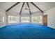 Inviting living room boasts a vaulted ceiling with exposed beams and large windows that bring the outdoors in at 450 Cassady St, Umatilla, FL 32784