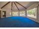 Spacious living room features a vaulted ceiling with beams and a wall of windows offering picturesque outdoor views at 450 Cassady St, Umatilla, FL 32784