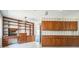 Home office with a built-in desk, vintage lighting fixture, and wood cabinets at 450 Cassady St, Umatilla, FL 32784