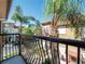 Scenic balcony view showcasing the neighborhood and palm trees under a clear blue sky at 4504 Messina Dr, Lake Mary, FL 32746