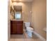 Bathroom featuring vanity with wood cabinets, mirror, and toilet at 4504 Messina Dr, Lake Mary, FL 32746