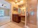 Bathroom view with a vanity featuring wood cabinets and a tiled shower at 4504 Messina Dr, Lake Mary, FL 32746