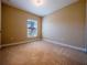 Bedroom featuring neutral carpet, baseboard trim and a bright window at 4504 Messina Dr, Lake Mary, FL 32746
