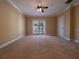 Bedroom features carpet flooring, ceiling fan, and balcony access at 4504 Messina Dr, Lake Mary, FL 32746