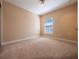 Bedroom featuring neutral carpet, baseboard trim and a bright window at 4504 Messina Dr, Lake Mary, FL 32746