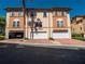 Exterior view of townhome with a two-car garage, brick paved driveway and tile roof at 4504 Messina Dr, Lake Mary, FL 32746