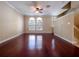 Open living room with hardwood floors, ceiling fan, and lots of natural light from the arched windows at 4504 Messina Dr, Lake Mary, FL 32746