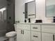 Modern bathroom featuring double sinks, white cabinets, quartz countertop, and a sleek, glass-enclosed shower at 489 Marion Oaks Golf Rd, Ocala, FL 34473
