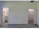 Bedroom showing open bathroom and closet doors, and gray wood flooring at 489 Marion Oaks Golf Rd, Ocala, FL 34473
