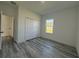 Bright bedroom with LVP flooring, a built-in closet and a window at 489 Marion Oaks Golf Rd, Ocala, FL 34473