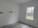 Bright bedroom featuring a window and horse themed wall decor; white walls enhance the room's airy feel at 489 Marion Oaks Golf Rd, Ocala, FL 34473