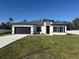 Charming single-Gathering home with a well-manicured lawn, a two-car garage, and a modern architectural style at 489 Marion Oaks Golf Rd, Ocala, FL 34473
