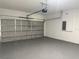 Spacious garage with a large gray door and painted floors perfect for parking and storage at 489 Marion Oaks Golf Rd, Ocala, FL 34473