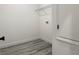 Clean laundry area features hookups, vinyl plank flooring and wire shelf at 489 Marion Oaks Golf Rd, Ocala, FL 34473