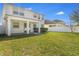 Spacious backyard with covered patio, lush green lawn, and white fence at 5029 Southlawn Ave, Orlando, FL 32811