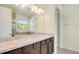 This bathroom boasts dual sinks, wood cabinetry, and a mirror with vanity lighting at 5029 Southlawn Ave, Orlando, FL 32811