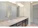 Bathroom with double sink vanity and large mirror. Includes two doors at 5029 Southlawn Ave, Orlando, FL 32811