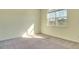 Bedroom with carpet flooring, a large window letting in light, and neutral walls at 5029 Southlawn Ave, Orlando, FL 32811