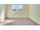 Bedroom with carpet flooring, a large window with neighborhood views, and neutral walls at 5029 Southlawn Ave, Orlando, FL 32811
