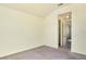 Neutral bedroom with carpet flooring and view of the house through a doorway at 5029 Southlawn Ave, Orlando, FL 32811