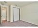 The room boasts an ample closet with sliding doors and neutral-colored walls and carpet at 5029 Southlawn Ave, Orlando, FL 32811