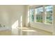 Sunlit bedroom featuring tile flooring, large windows, and bright neutral walls at 5029 Southlawn Ave, Orlando, FL 32811