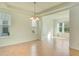 Open dining room with tile floors, a modern chandelier, and plenty of natural light at 5029 Southlawn Ave, Orlando, FL 32811