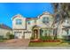 Charming two-story home with a brick driveway, two-car garage and manicured landscaping at 5029 Southlawn Ave, Orlando, FL 32811