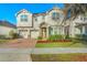 Charming two-story home featuring a brick driveway, two-car garage and manicured landscaping at 5029 Southlawn Ave, Orlando, FL 32811