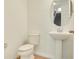 Neat powder room boasts a pedestal sink and ceramic tile flooring for a clean look at 5029 Southlawn Ave, Orlando, FL 32811