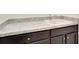This utility sink features wood cabinetry and a stone counter at 5029 Southlawn Ave, Orlando, FL 32811