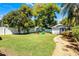 Spacious yard featuring well-manicured lawn, garden path, detached structure, and play set at 515 Clayton St, Orlando, FL 32804