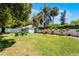 Expansive backyard with play set, seating, manicured landscaping, and privacy fence at 515 Clayton St, Orlando, FL 32804