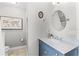 Clean bathroom featuring a marble countertop vanity, tile flooring, and a decorative oval mirror at 515 Clayton St, Orlando, FL 32804