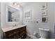 Charming bathroom featuring a classic vanity, neutral walls, and decorative floral art at 515 Clayton St, Orlando, FL 32804
