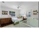 Light-filled Bedroom with crib, daybed, ceiling fan, and ample natural light from the two windows at 515 Clayton St, Orlando, FL 32804