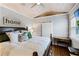 Inviting bedroom with a king-sized bed, whitewashed wood walls, tray ceiling, and hardwood floors at 515 Clayton St, Orlando, FL 32804