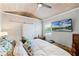 Comfortable bedroom with a king-sized bed, shiplap accent wall, ceiling fan, and television at 515 Clayton St, Orlando, FL 32804