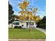 Charming home featuring a manicured lawn, mature tree, and welcoming porch at 515 Clayton St, Orlando, FL 32804