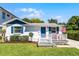 Charming single-Gathering home with a quaint front porch, American flag, blue shutters, and freshly cut grass at 515 Clayton St, Orlando, FL 32804