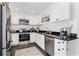 Well-appointed kitchen with white cabinets, stainless steel appliances, subway tile backsplash, and dark tile floor at 515 Clayton St, Orlando, FL 32804