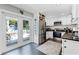Modern kitchen with white cabinets, stainless steel appliances, black countertops, and access to the outdoor deck at 515 Clayton St, Orlando, FL 32804