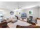 Cozy living room featuring neutral decor, a ceiling fan, television, and hardwood floors at 515 Clayton St, Orlando, FL 32804