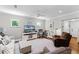 Bright and airy living room with hardwood floors, neutral walls, large windows, ceiling fan, and comfortable seating at 515 Clayton St, Orlando, FL 32804